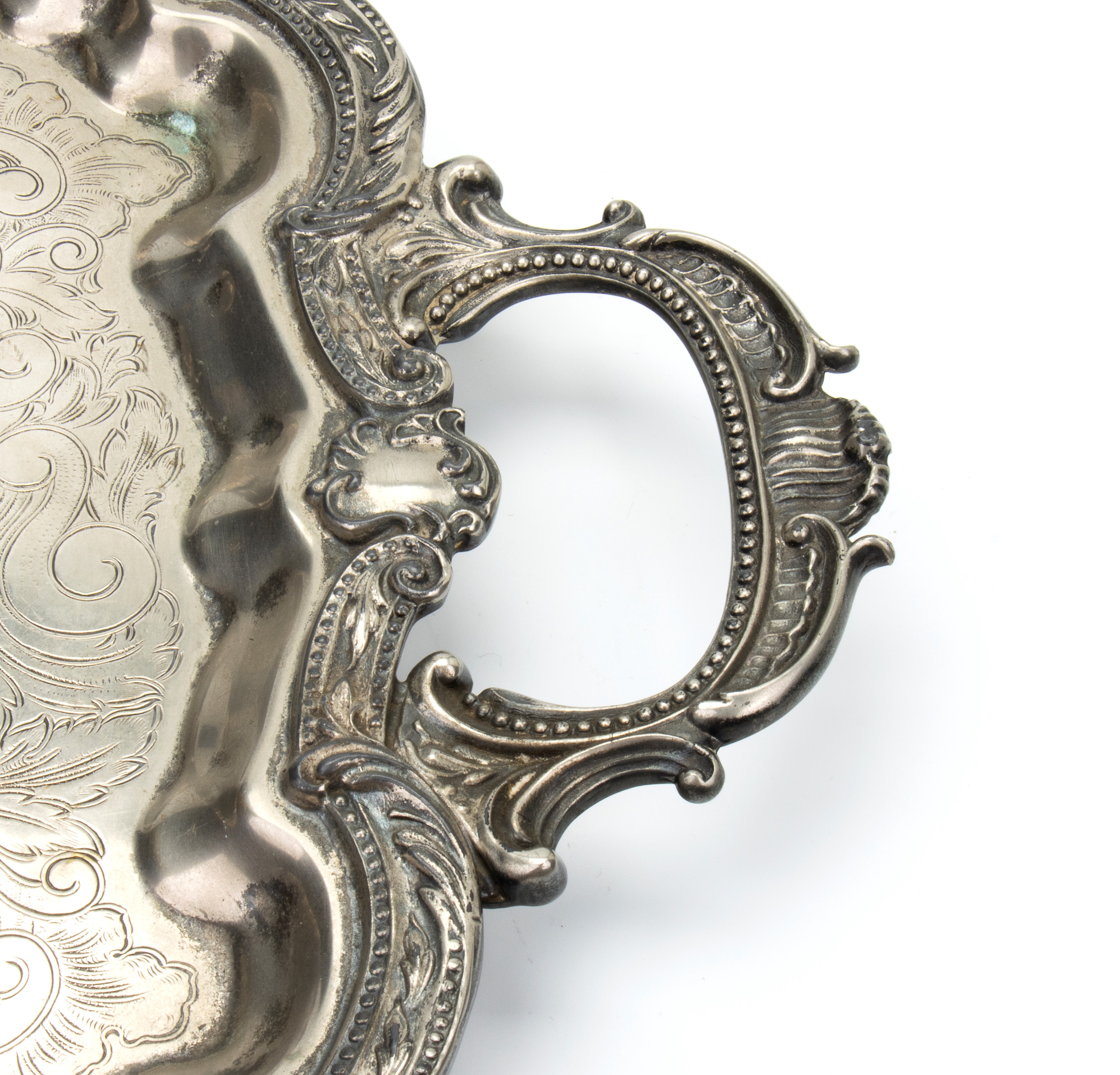 Vassoio con grandi manici e bordo mistilineo arricchito da decoro di foglie a rilievo