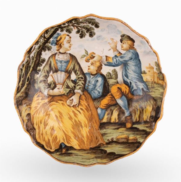 Manifattura Gentili, Castelli, XVIII secolo - Coppetta in maiolica decorata in policromia con scena galante e paesaggio con figure e case sullo sfondo. 