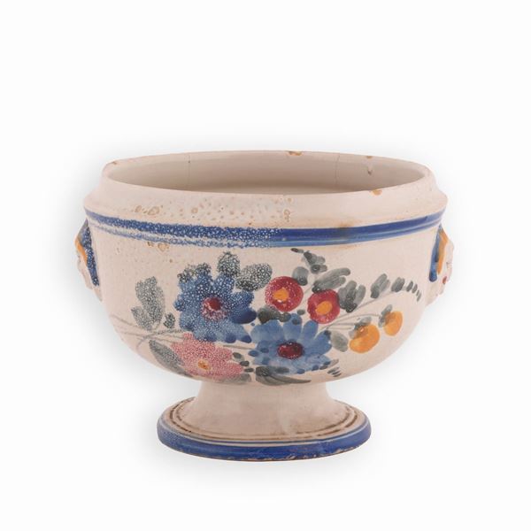 Manifattura castellana del XIX secolo - Zuppiera in maiolica decorata in policromia con motivi floreali e bordatore in blu. Ai lati mascheroni. 