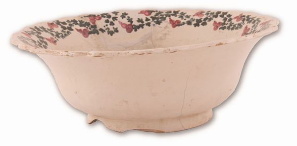 Manifattura castellana del XIX secolo - Grande piatto in maiolica decorato sulla tesa con ghirlanda e sul cavo con un mazzetto floreale