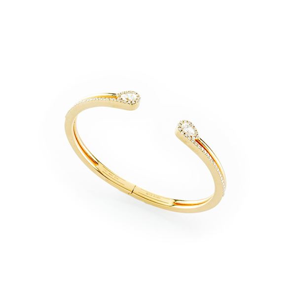 18 kt yellow gold bangle embellished by brilliant and pear-cut diamonds