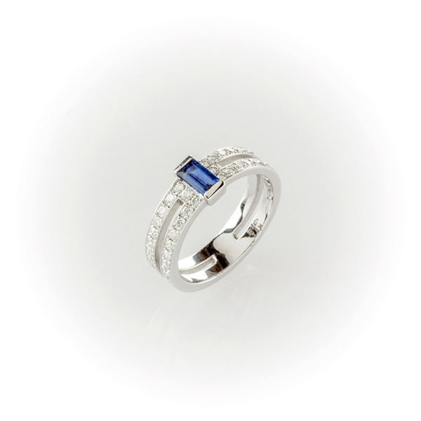 White gold band ring with brilliant cut diamonds and blue sapphire rectangular cut.