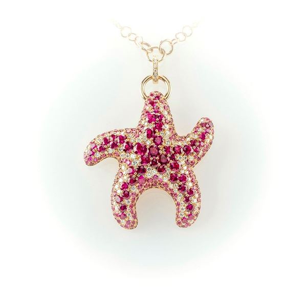 Necklace in rose gold with pendant shaped like a starfish embellished with round cut rubies, round cut pink sapphires and brilliant cut white diamonds. 