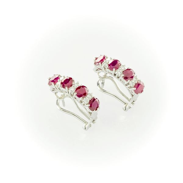 White gold earrings with oval cut rubies and brilliant cut diamonds