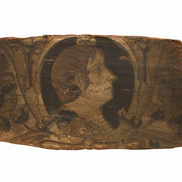 Profilo di figura virile in ricco cartiglio a racemi.