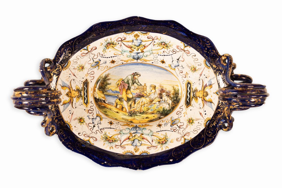 Coppia di centrotavola in maiolica con anse serpentiformi e zampe leonine. Manifattura A. Ciulli,...