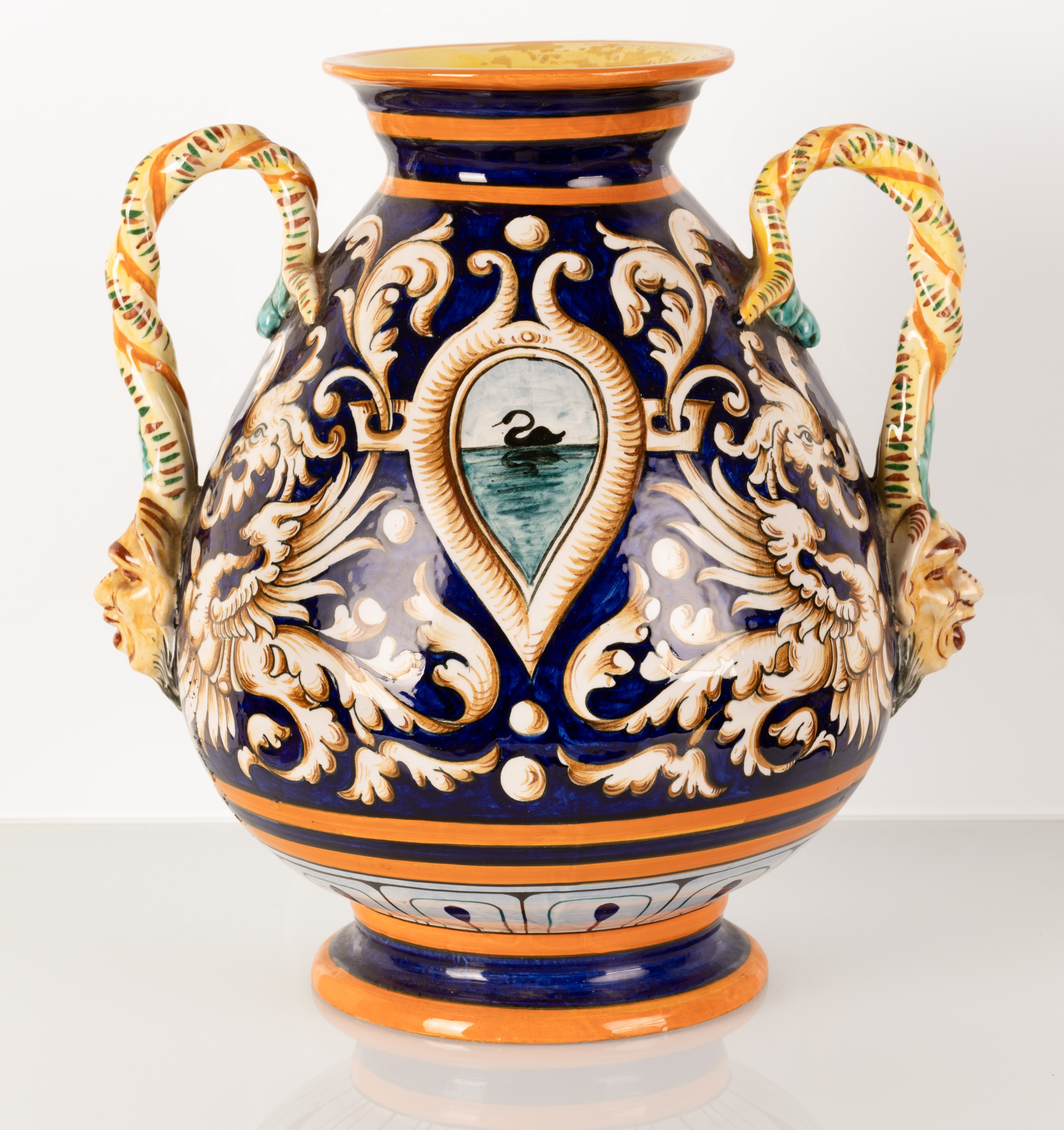 Vaso in maiolica biansato con anse ritorte terminanti a mascheroni antroomorfi. Manifattura Egist...