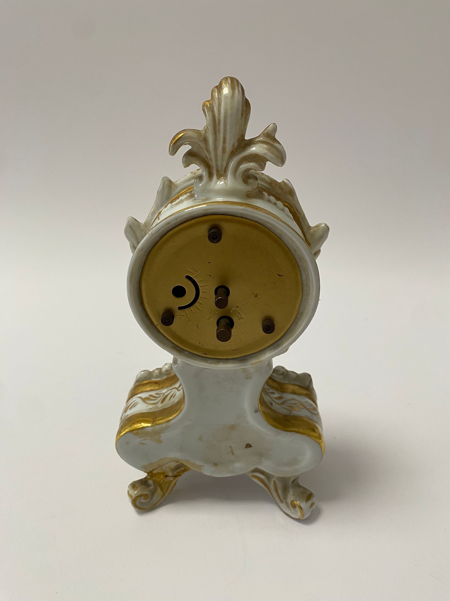 Piccolo orologio da camino in porcellana di Capodimonte con ricche volute e decori floreali