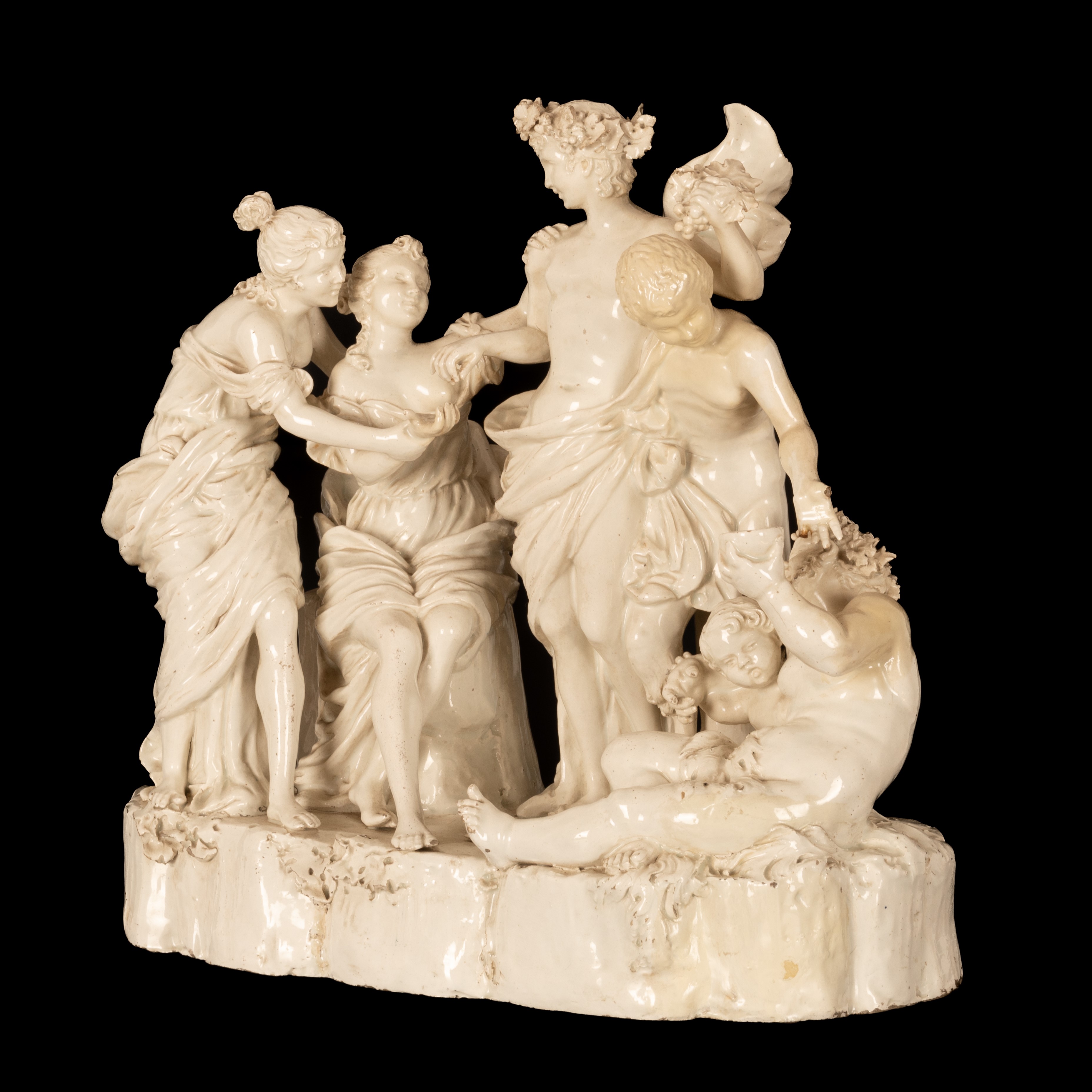 Gruppo scultoreo in terraglia raffigurante Bacco assistito dai satiri e da due menadi