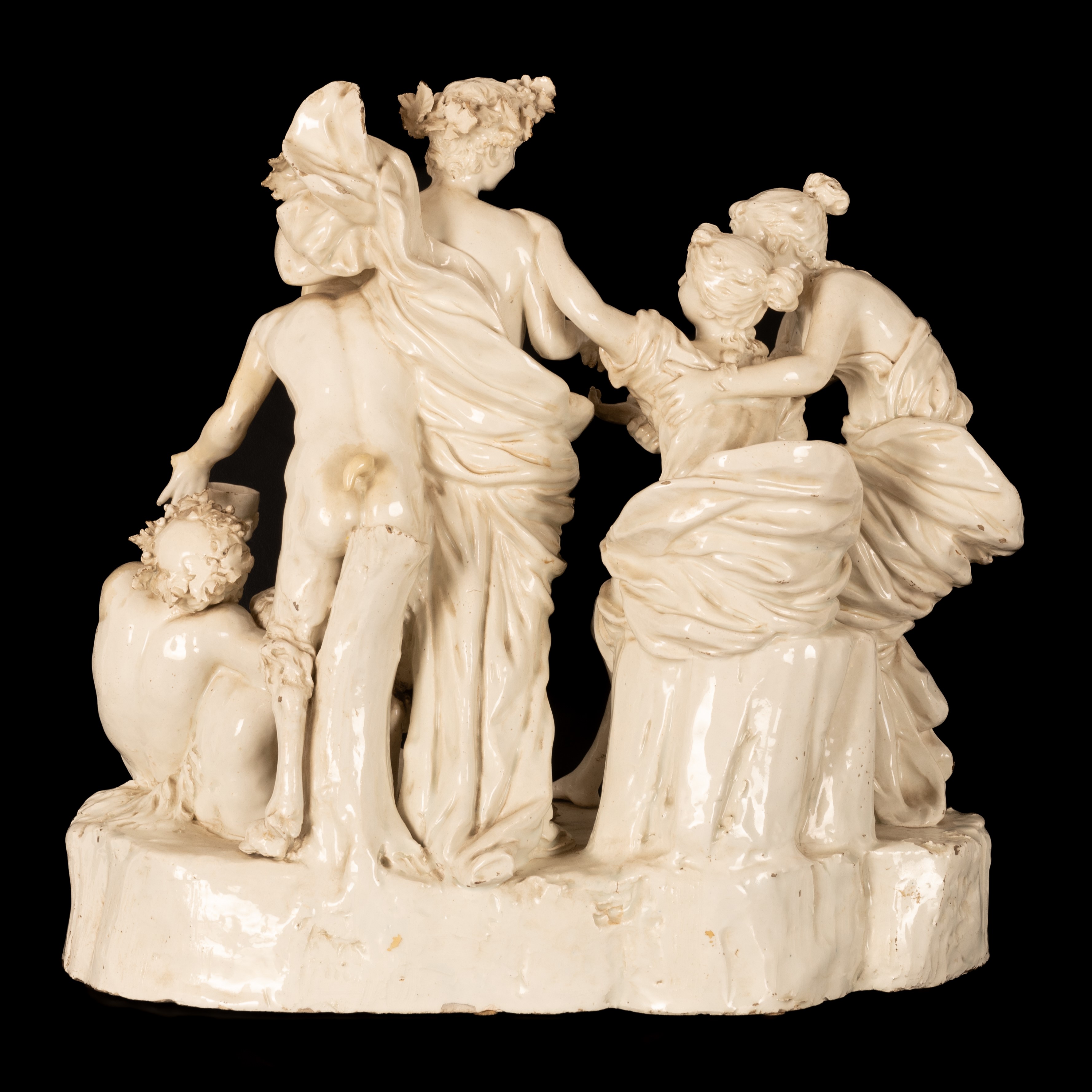 Gruppo scultoreo in terraglia raffigurante Bacco assistito dai satiri e da due menadi