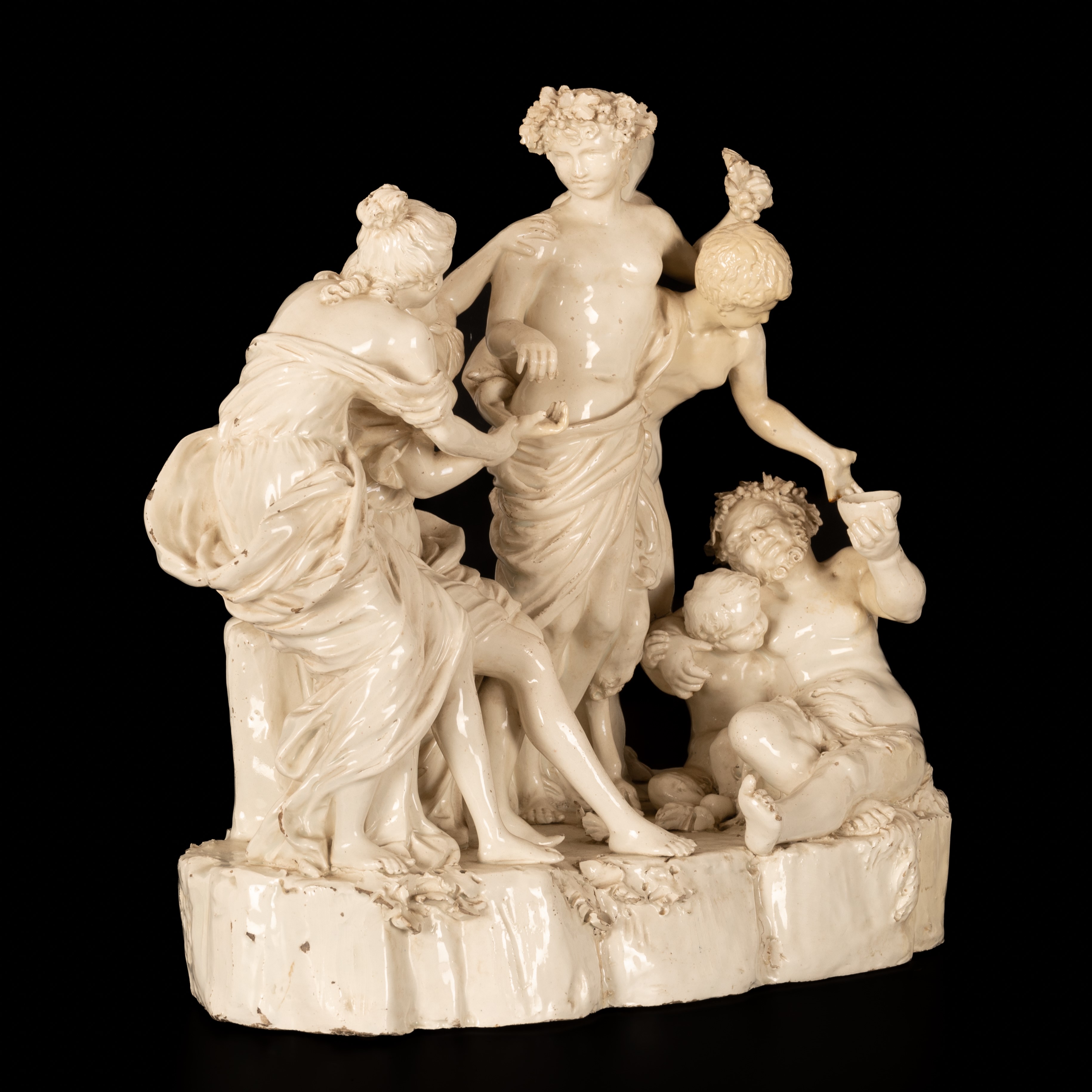 Gruppo scultoreo in terraglia raffigurante Bacco assistito dai satiri e da due menadi