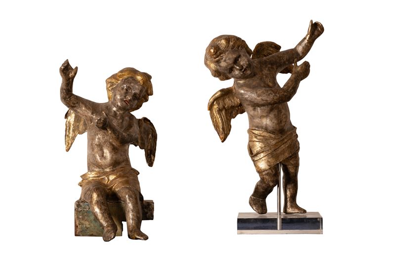 Coppia di putti in cartapesta argentata e dorata